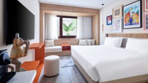Modern Hyatt Centric Cairo West room with a large bed, window seat, art, and flat-screen TV.