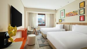 Modern Hyatt Centric Cairo West room with two beds, wall art, and a large window.