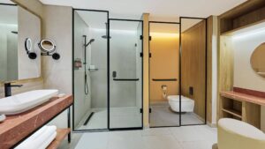Modern Hyatt Centric Cairo West bathroom with glass shower, vanity, and wooden accents.