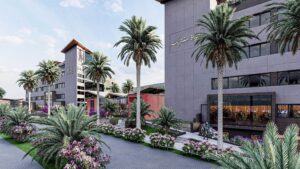 Modern buildings and palm trees surround Hyatt Centric Cairo West, with people strolling nearby.