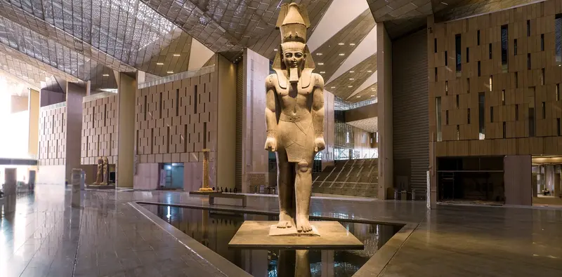 Large ancient Egyptian statue showcased in a modern museum—perfect for Egypt holidays inspiration.