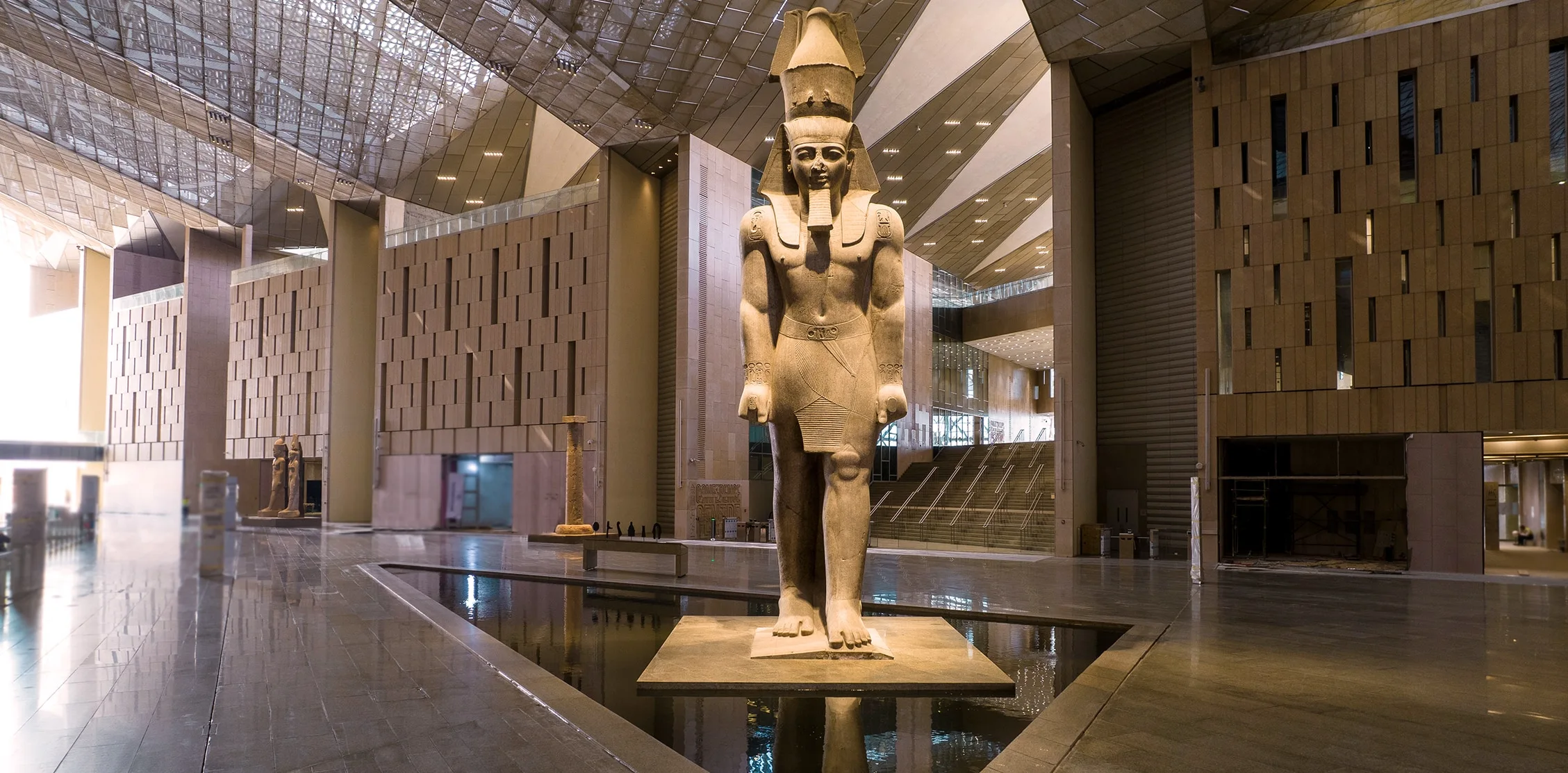 Large ancient Egyptian statue displayed in a modern museum—perfect for Egypt holidays.